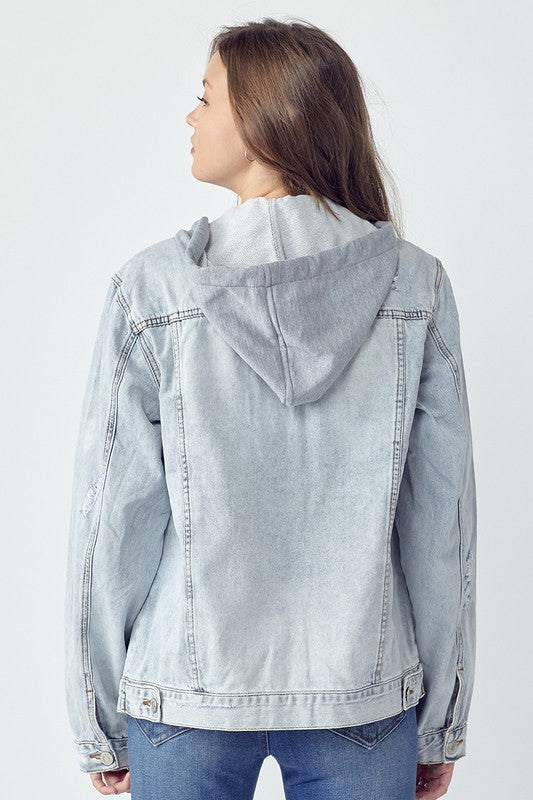 RISEN Relaxed Fit Distressed Drawstring Hooded Denim Jacket. Light acid wash denim jacket with removeable hood, a button down front, button cuffs, front button pockets, additional side pockets, and a relaxed fit.