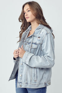 RISEN Relaxed Fit Distressed Drawstring Hooded Denim Jacket. Light acid wash denim jacket with removeable hood, a button down front, button cuffs, front button pockets, additional side pockets, and a relaxed fit.