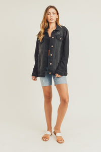 RISEN Black Vintage Wash Oversized Denim Jacket. Vintage wash black denim jacket with distressed details, button down front, button cuffs, front button pockets, additional side pockets, and a relaxed fit.