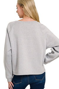 Grey Fleece Raglan Sleeve Pullover & Sweatpants Lounge Set. Two-piece fleece lined including a relaxed fit pullover top and straight cut pants with pockets. 