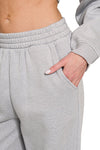 Grey Fleece Raglan Sleeve Pullover & Sweatpants Lounge Set. Two-piece fleece lined including a relaxed fit pullover top and straight cut pants with pockets. 