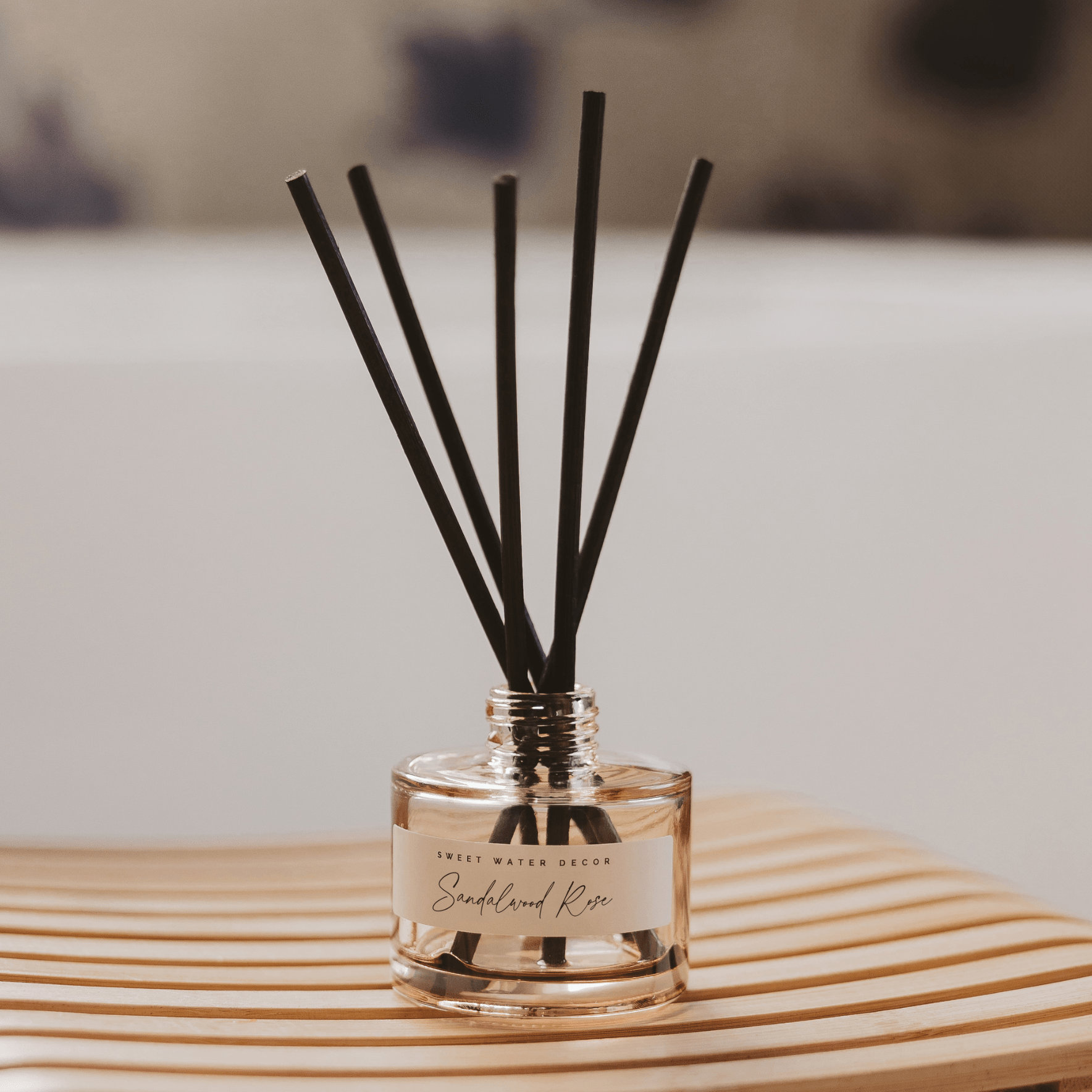 Sweet Water Decor Sandalwood Rose Tinted Glass Jar Reed Diffuser