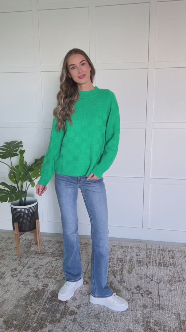 Featuring a round ribbed neckline, sleeve cuff, and hemline. This cheery green knit top with a subtle monochromatic checkered pattern will brighten up a cold winter day!